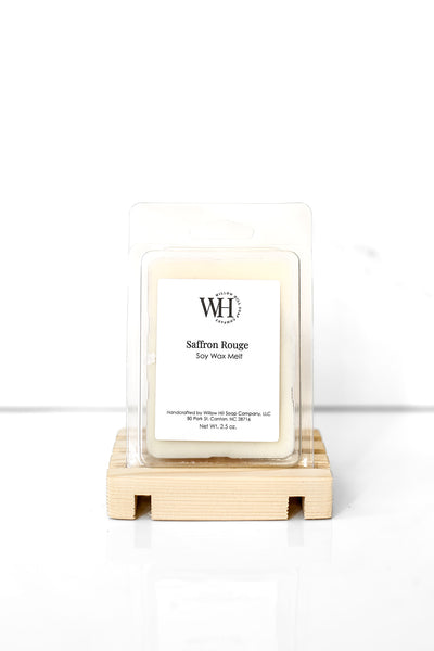 Willow Hill Soap Company Saffron Rouge soy wax melt in a container on a wooded stand. 
