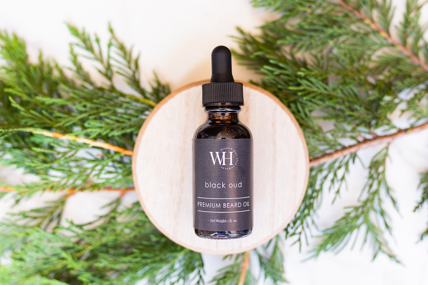 Willow Hill Soap Company Black Oud premium bead oil on wood plate with pine 