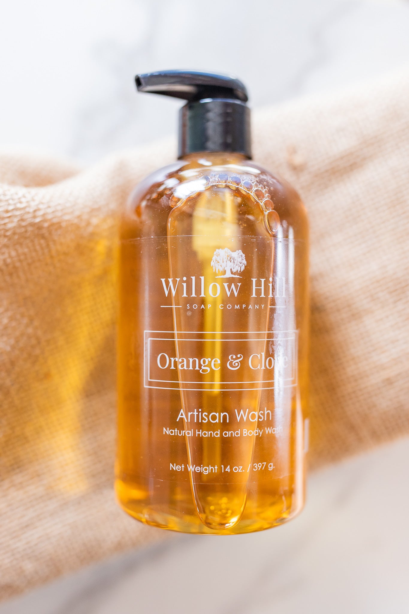 Willow Hill Soap Company Orange and Clove hand and body wash on a blanket